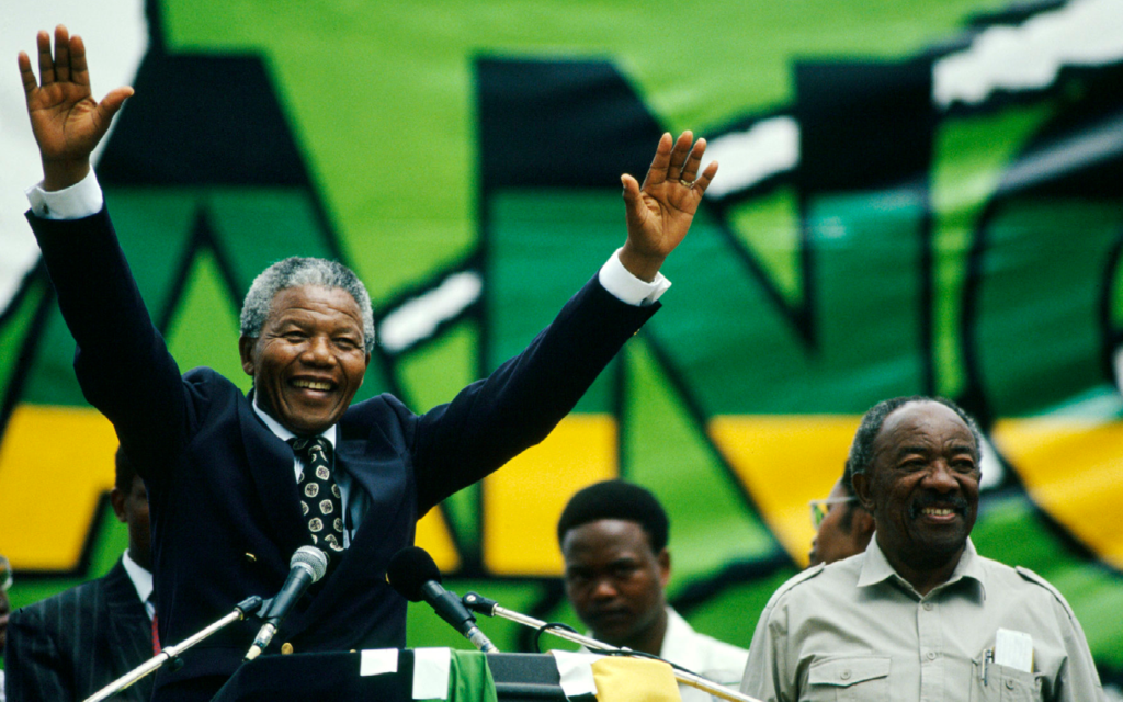 Nelson Mandela raising his hands
