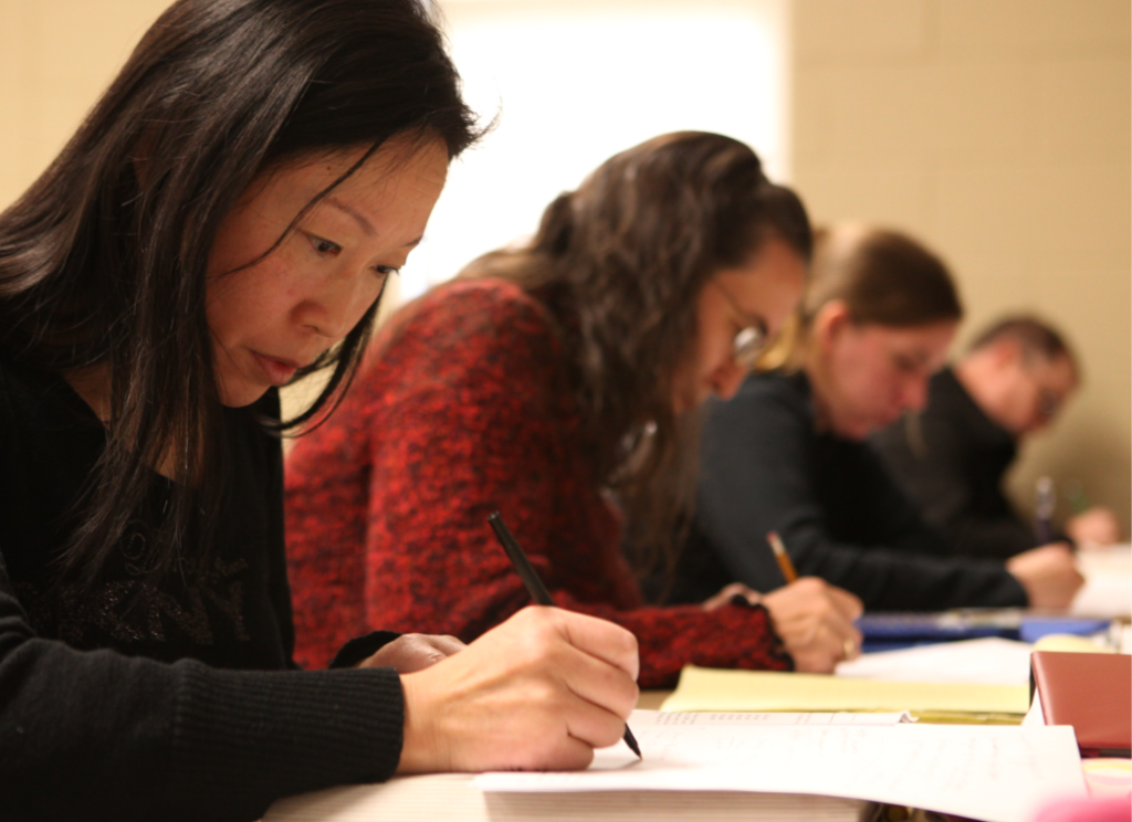 Students writing in a classroom