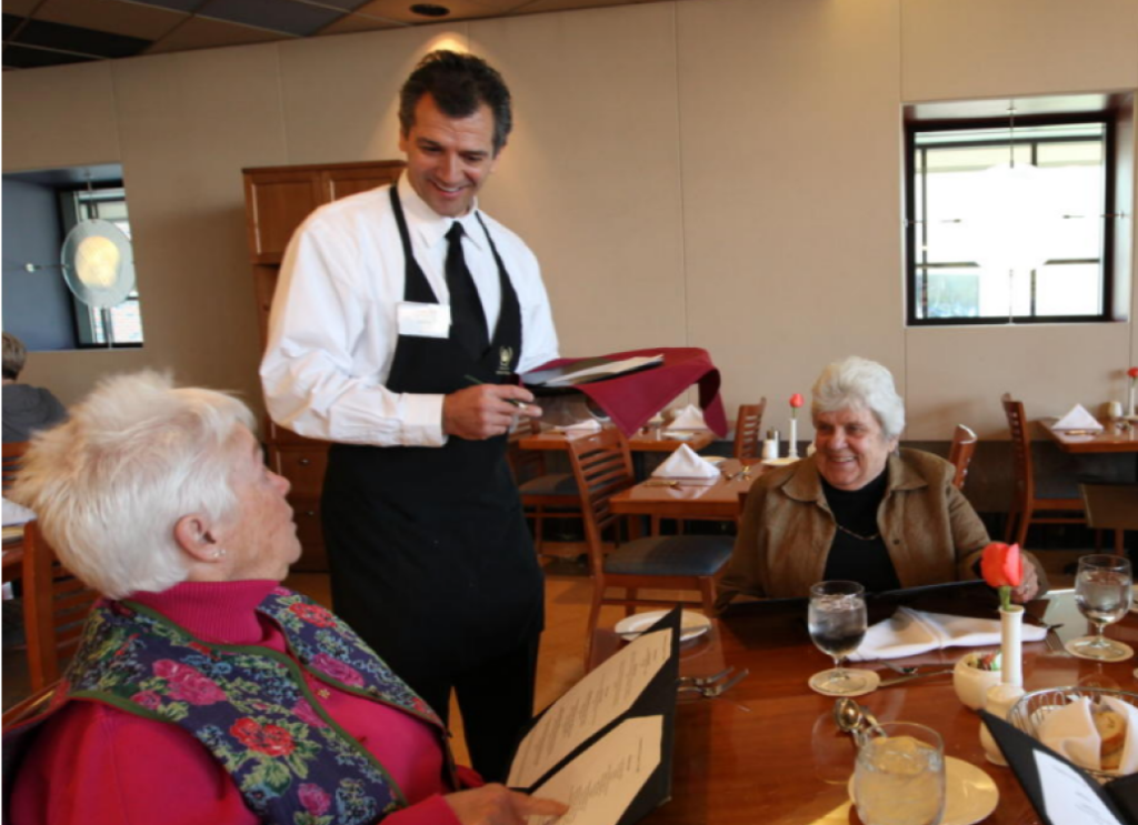 Server waiting on restaurant guests