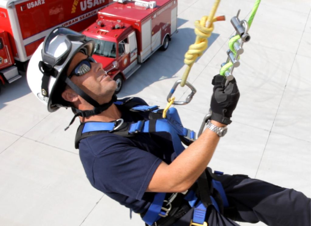 Firefighter going down ropes