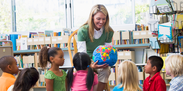 Teacher working with young students