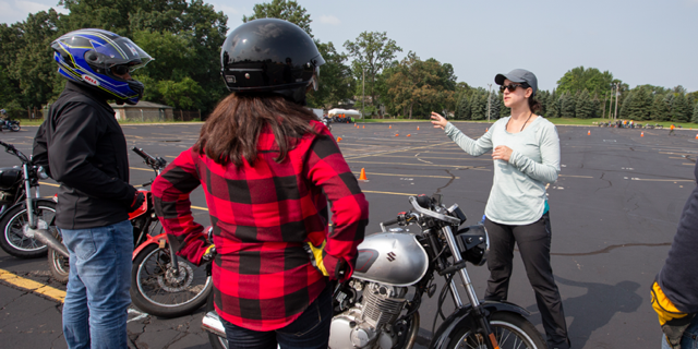 People talking around motorcycles