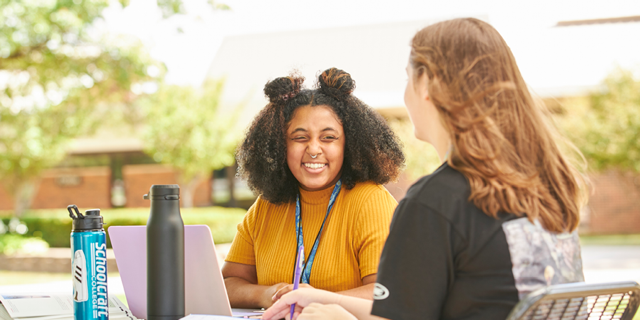 students sitting outside