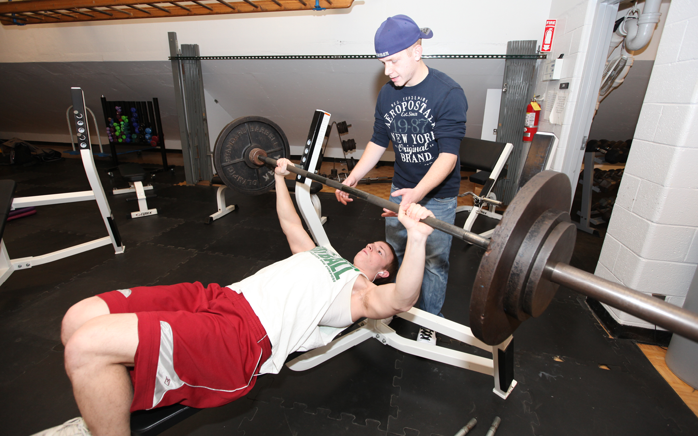 Person lifting weights with assistance