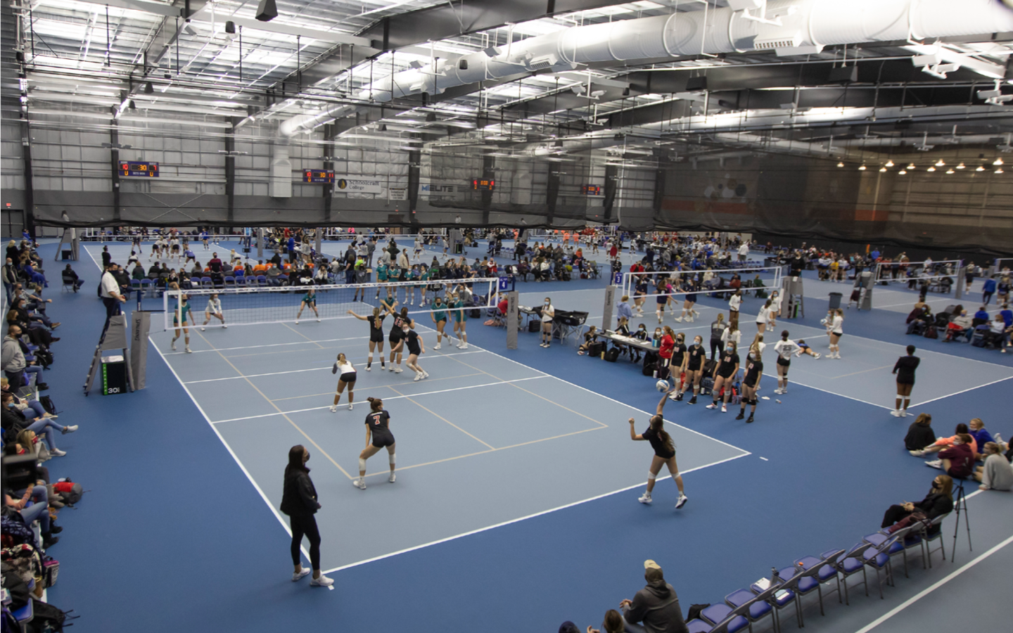 multiple volleyball court games going on