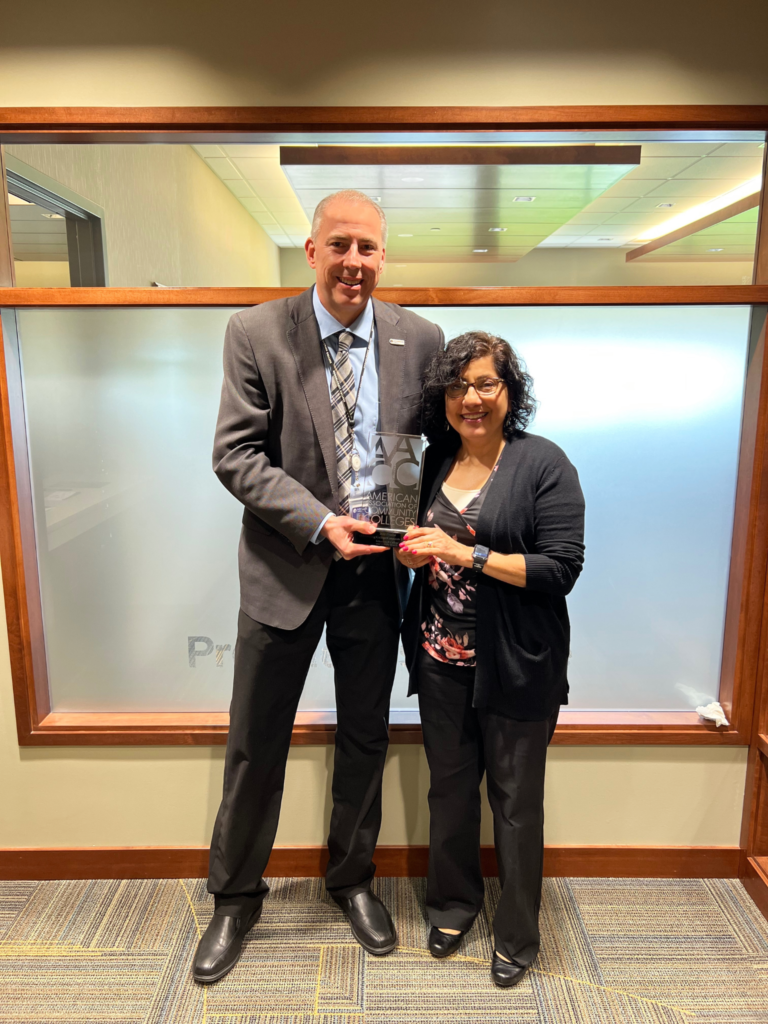 two people holding an award