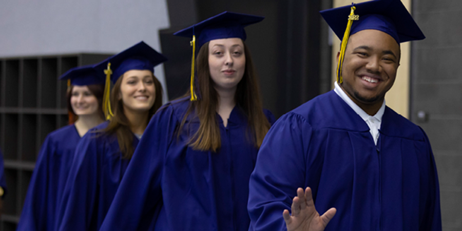 graduates in line and smiling