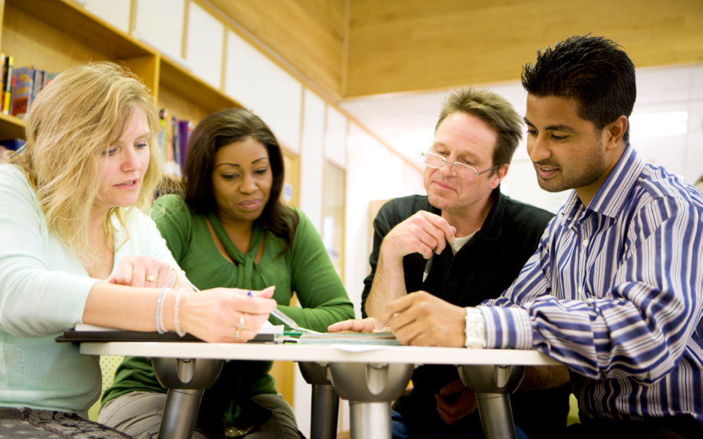 Four people working together at a table