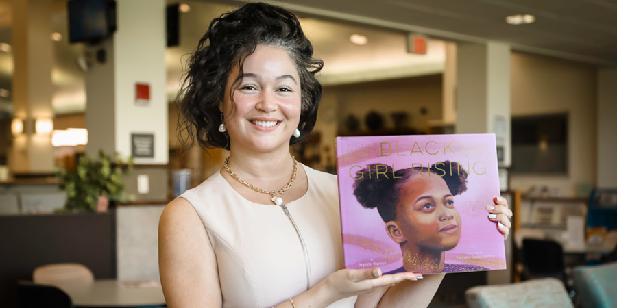 Brynne Barnes holding a copy of "Black Girl Rising"