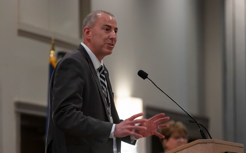 Dr. Cerny speaking at a podium