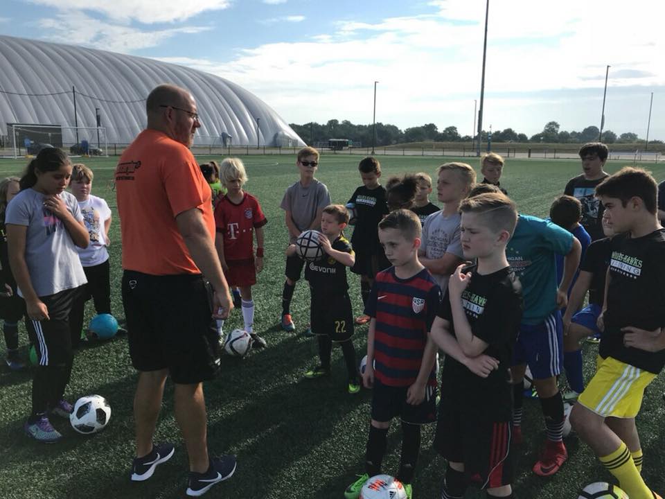 coach talking to youth soccer team