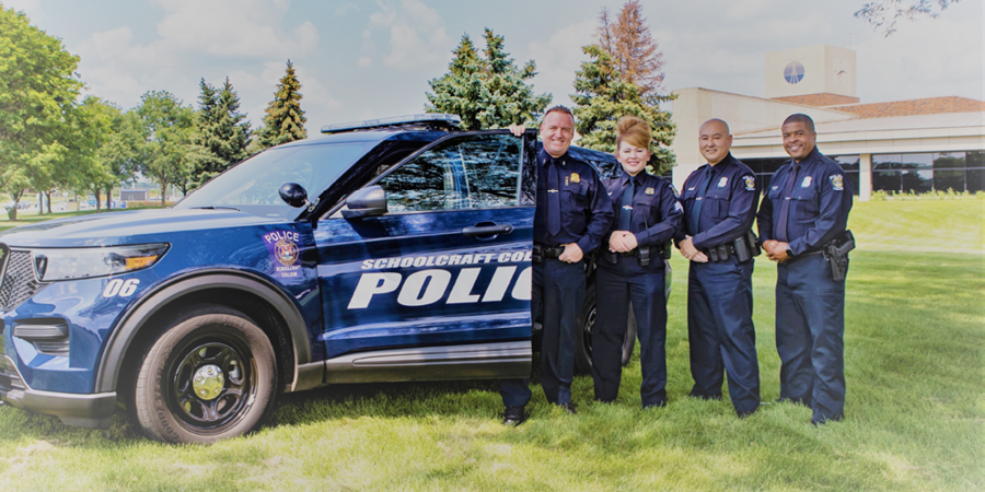 officers pose with police car