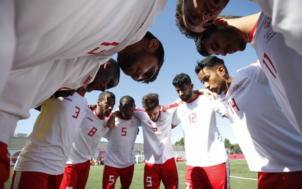 soccer team huddles in circle