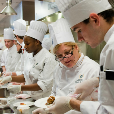 many chefs working in a kitchen