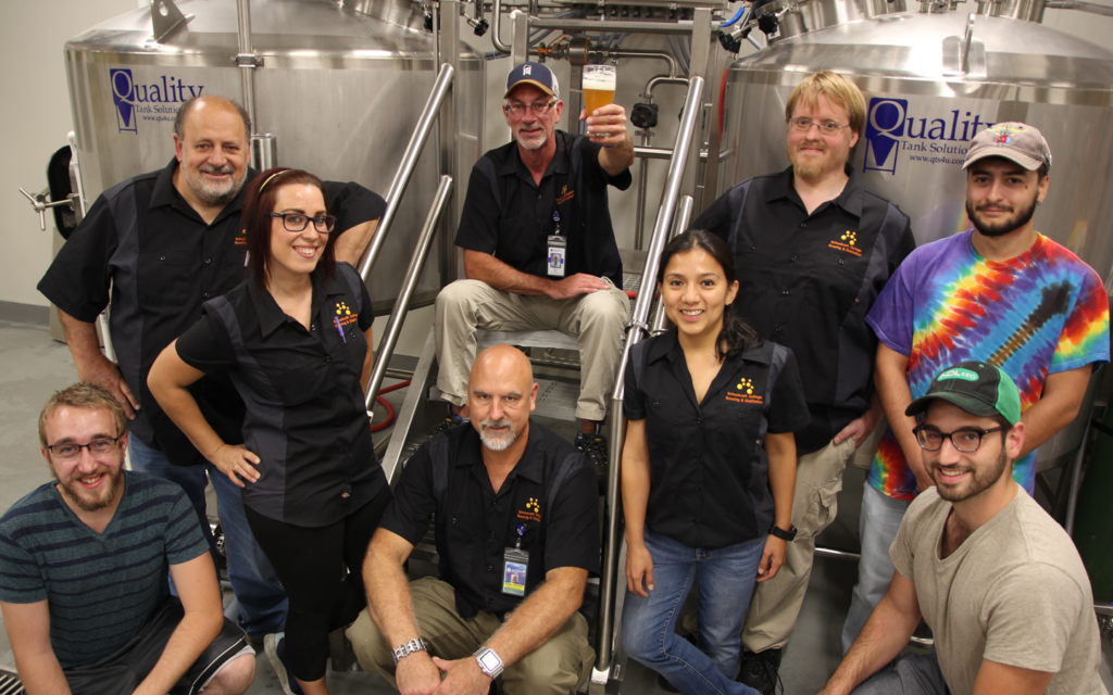 Group of people in brewing distillery