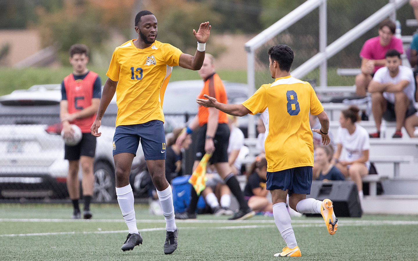 two men's soccer players high fiving