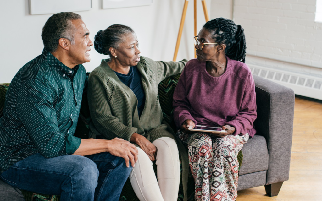 three people conversing