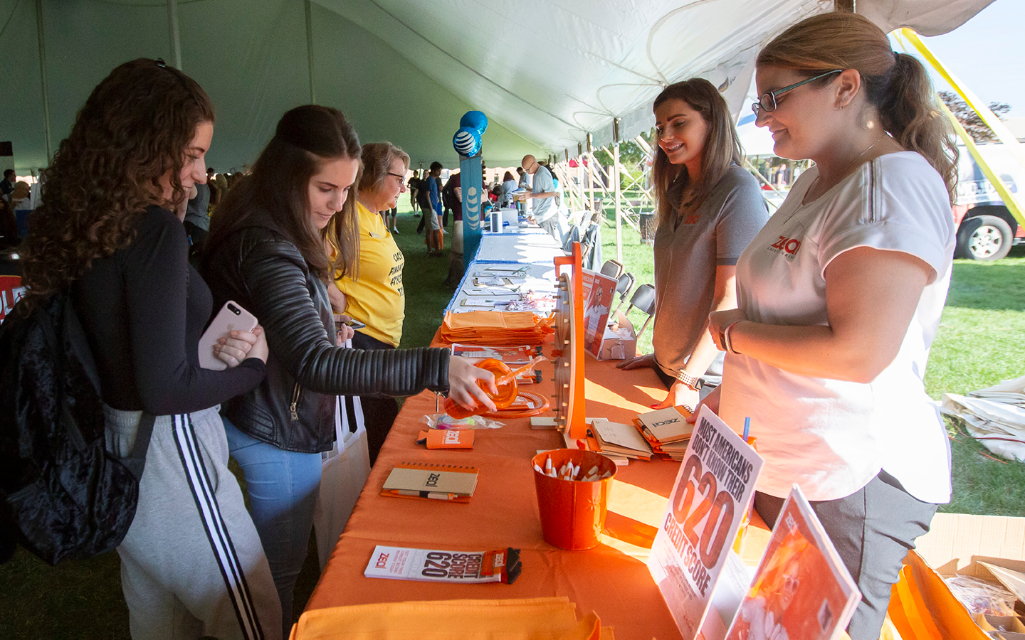 students visiting a table vendor