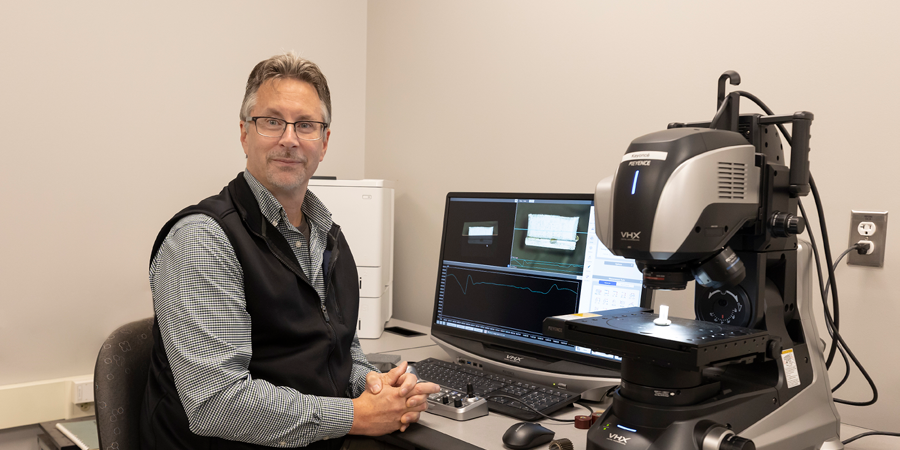 Dennis Fohey sitting in front of a computer