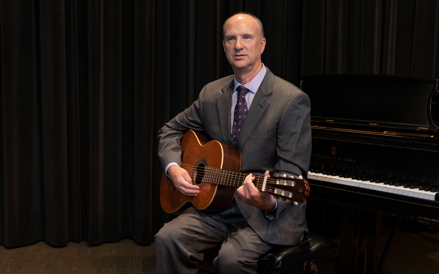 Dr. Frederick Moss holding guitar