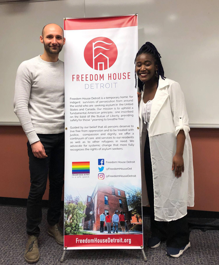 people standing around Freedom House banner