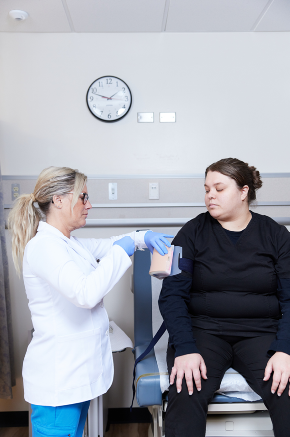 doctor taking measurement on patient's arm