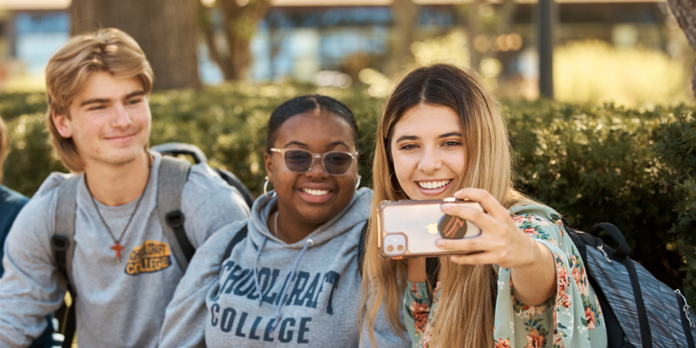 students taking group selfie