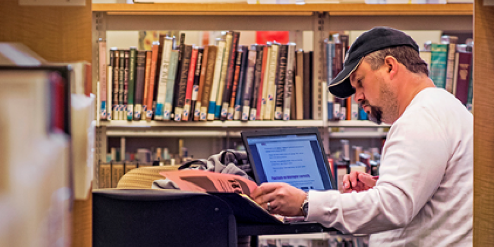 student studying at library desk