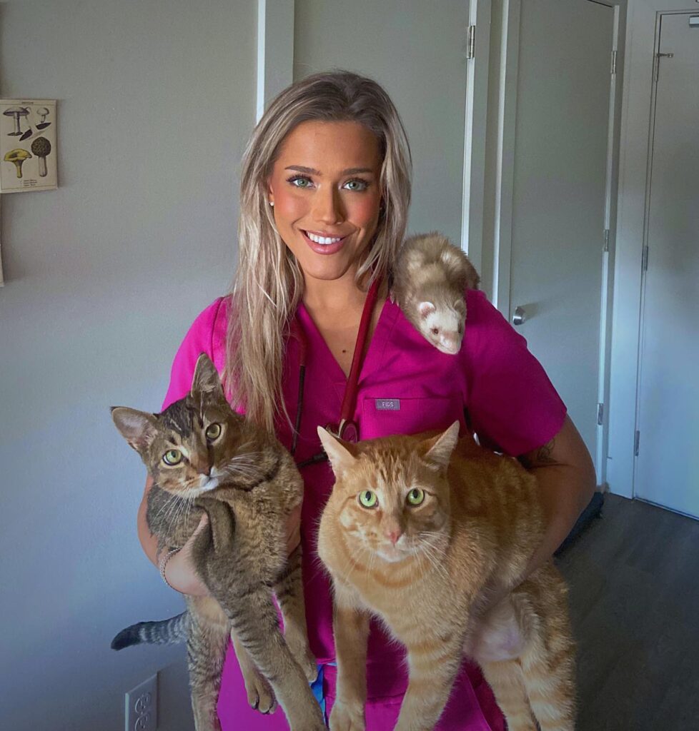 Ava holding three cats