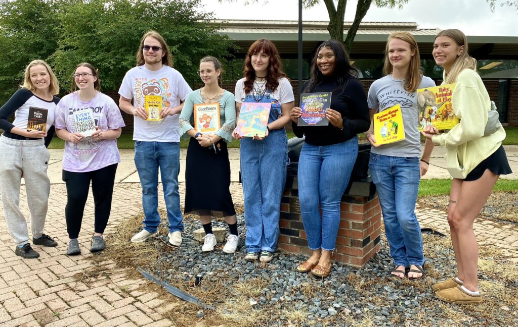 group of students holding books