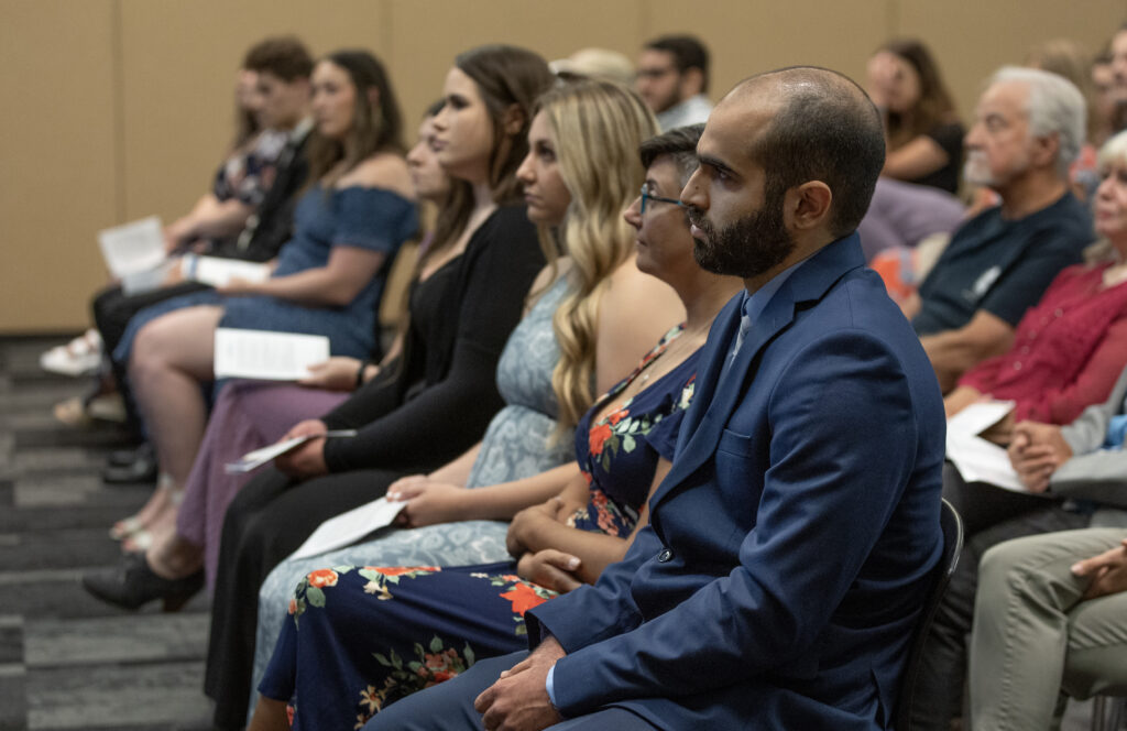 attendees watching the pinning ceremony