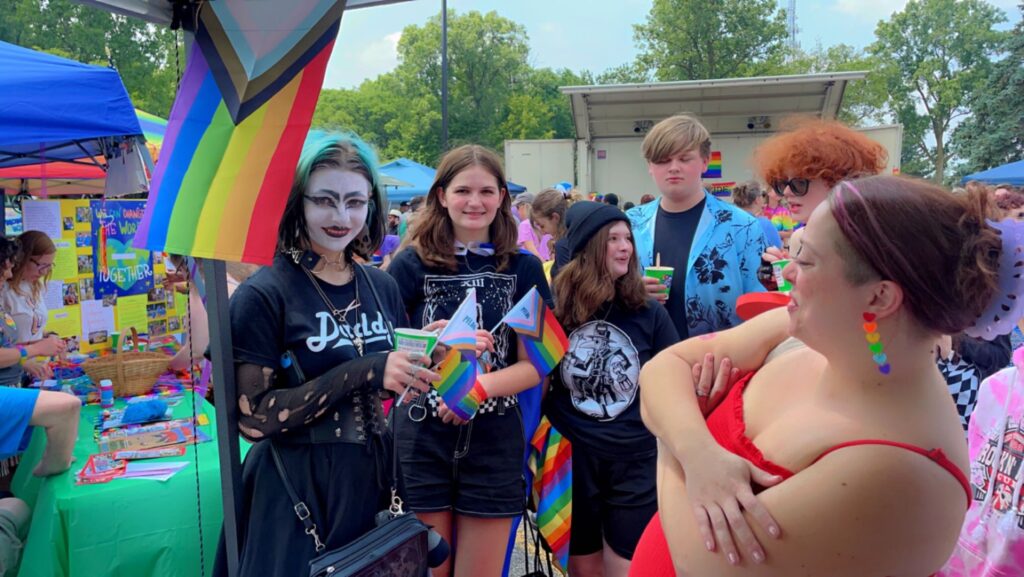 people gathered, one person has a face painting