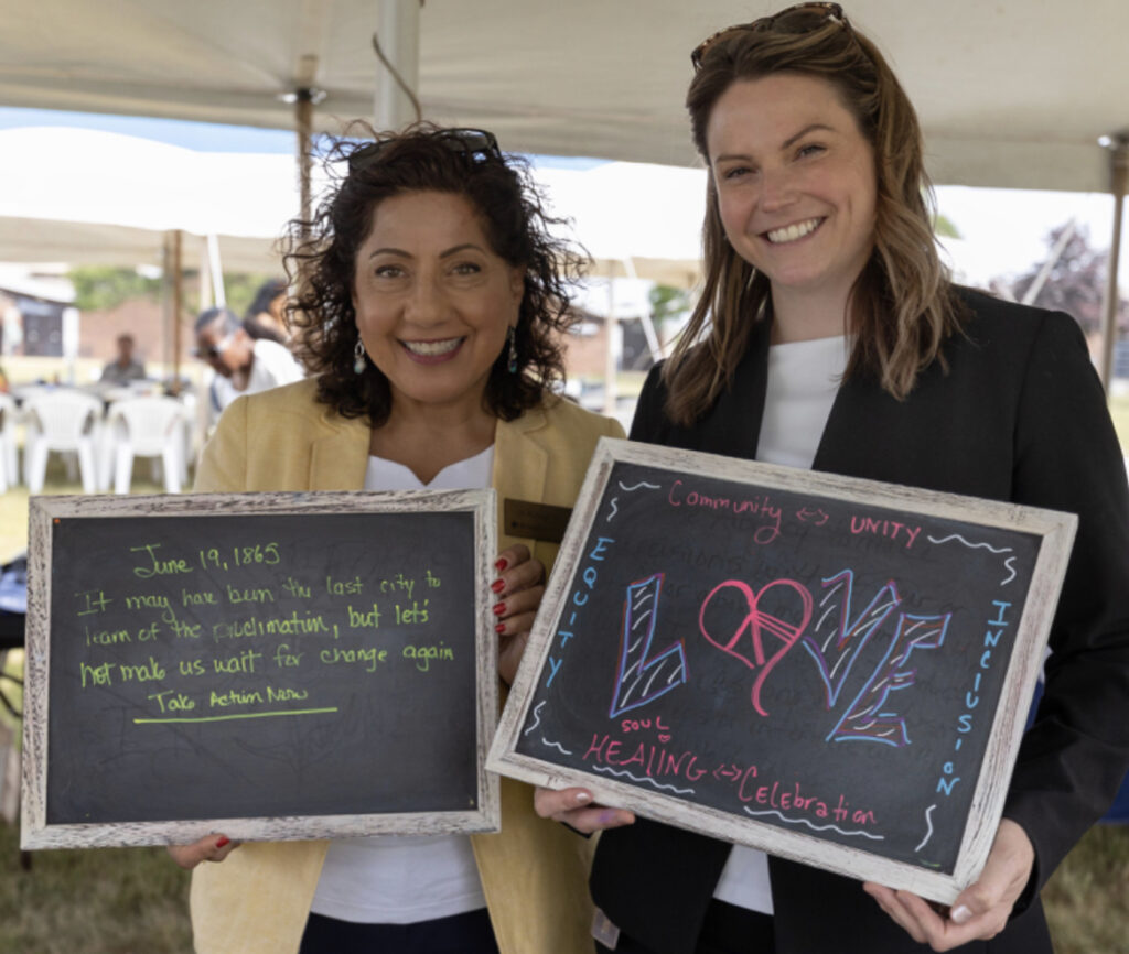 two people hold small chalkboard signs that read positive messages