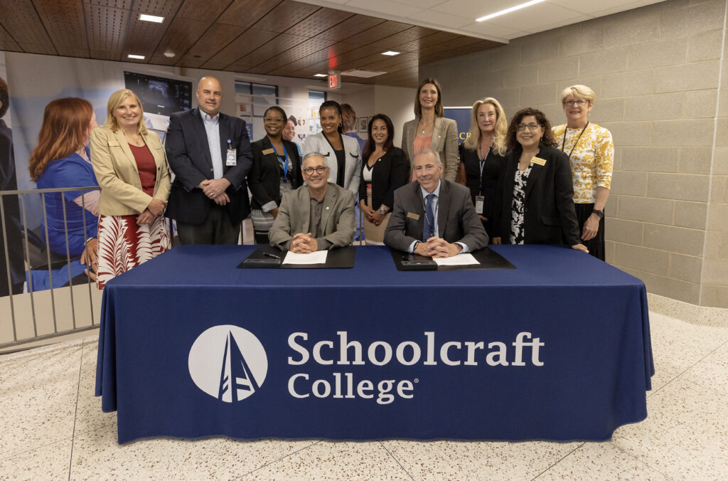 group photo of leadership behind a table