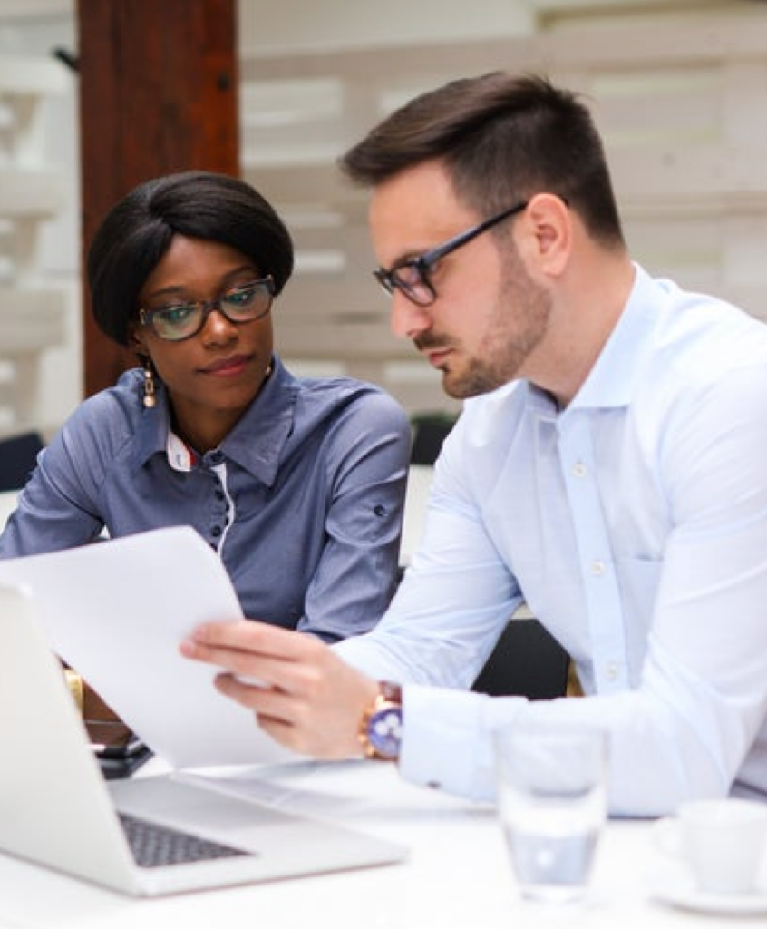 two business professionals looking at a paper