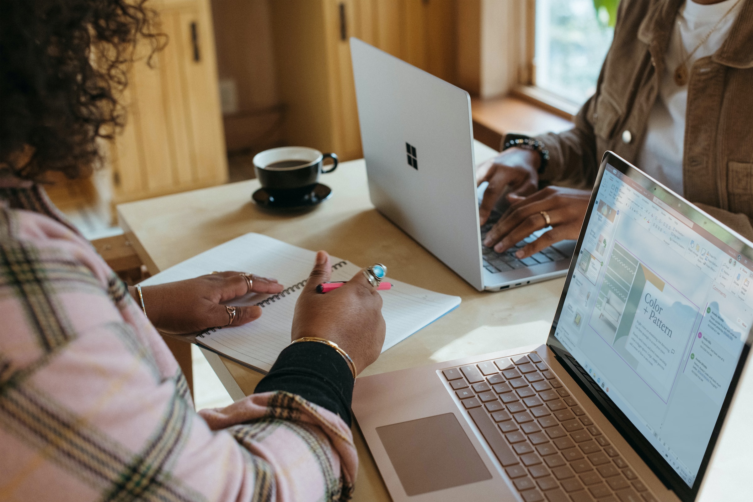 two people with their laptops at table