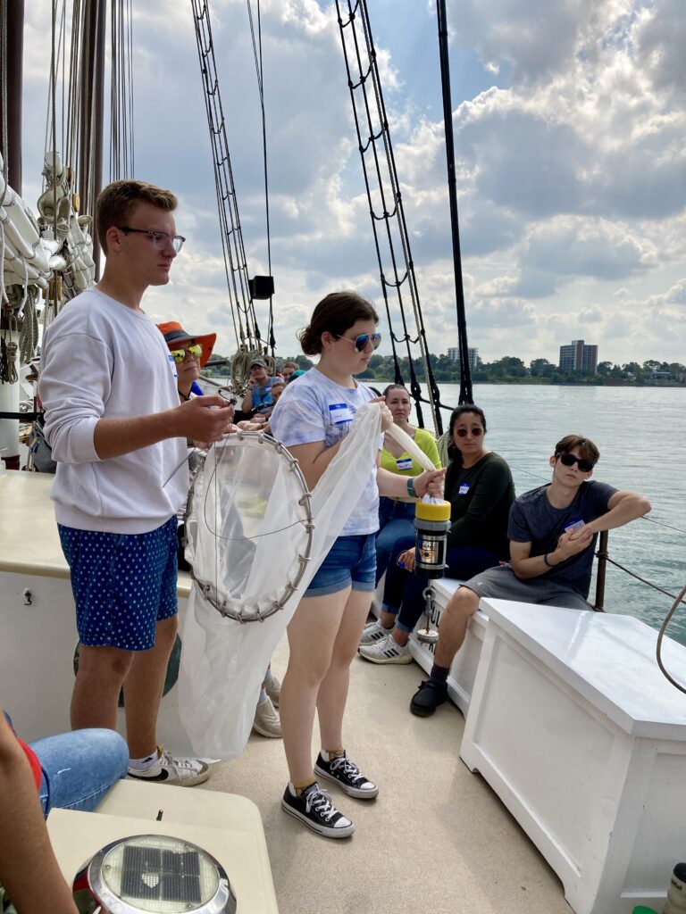 two people looking off the side of a boat