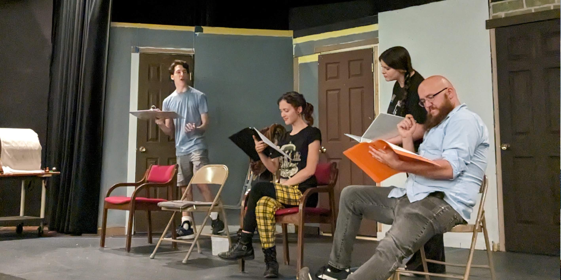Actors reading on a stage set