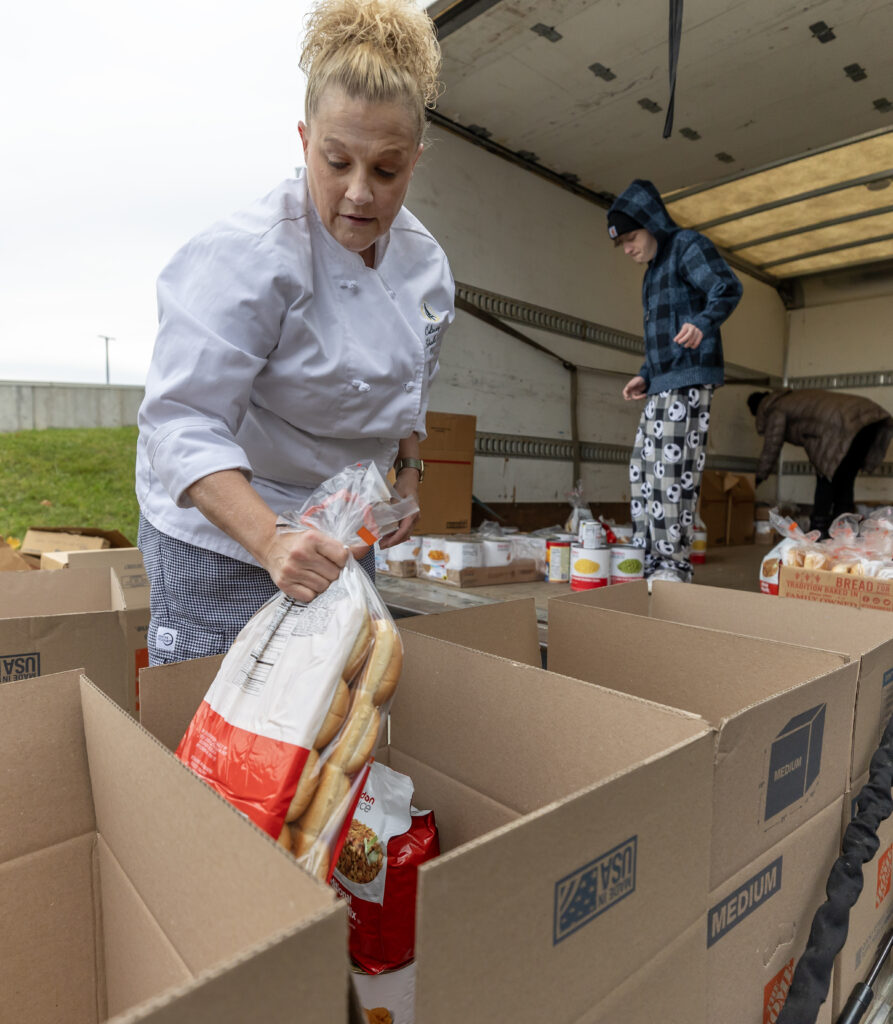 person putting food inside boxes