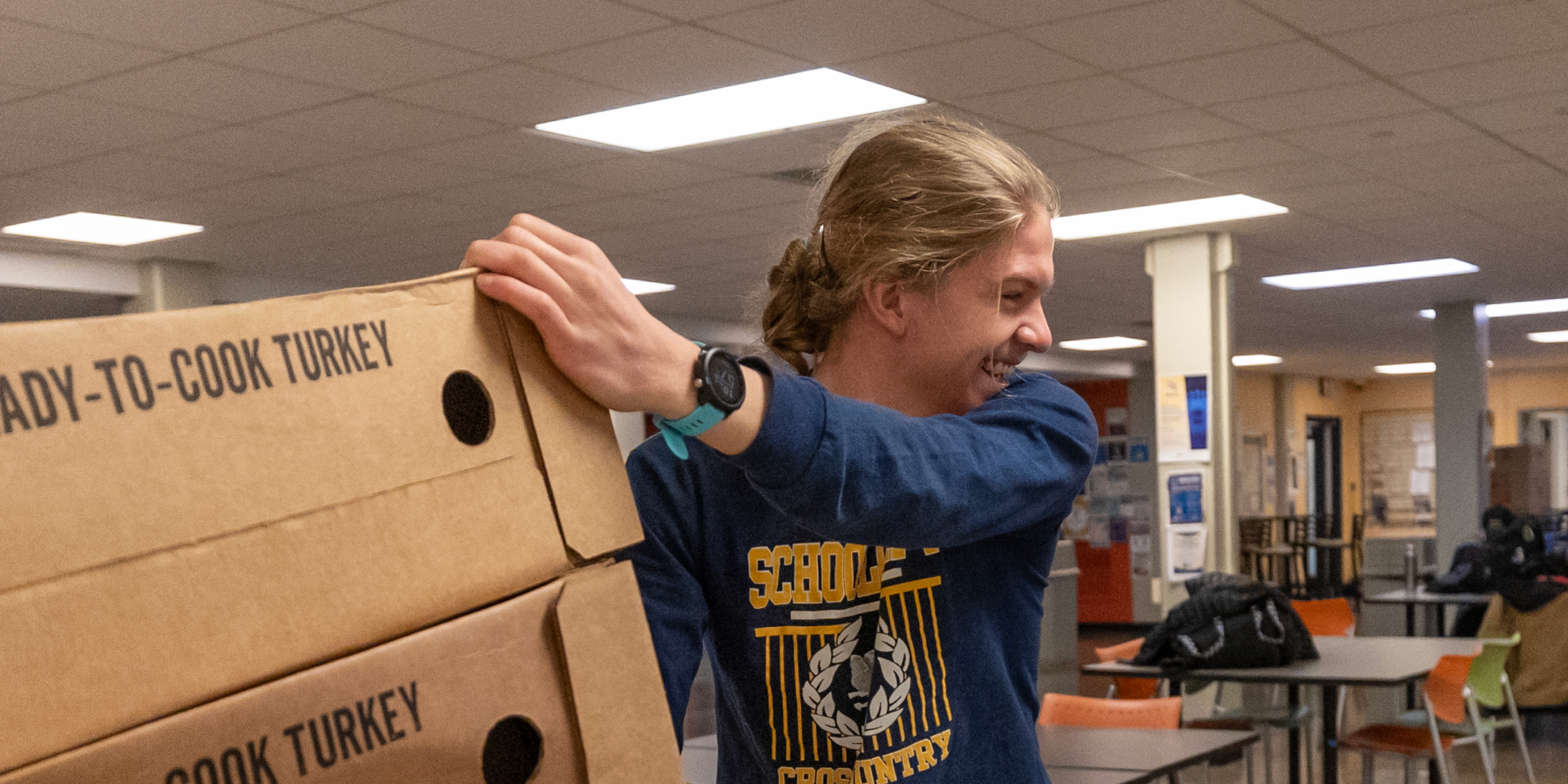 person carting boxes on a lift