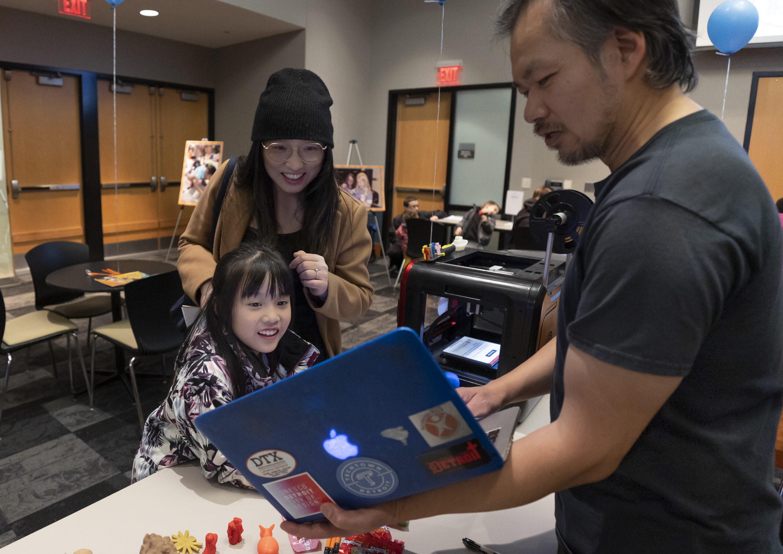 smiling child looking at laptop screen