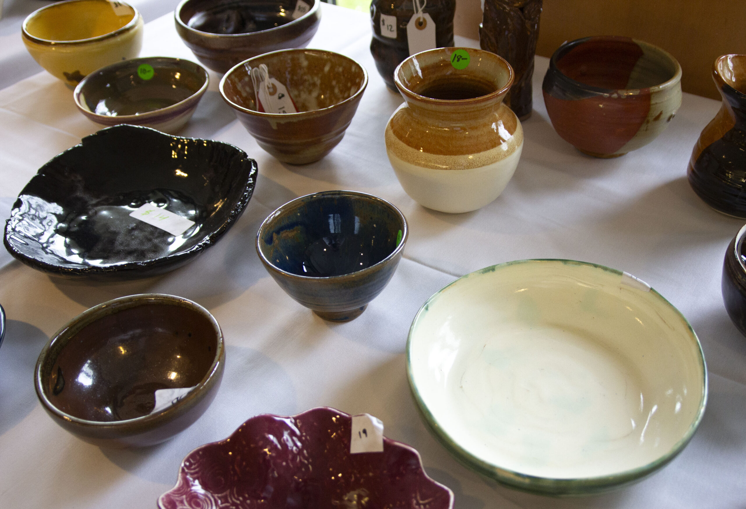 a table with variety of ceramic bowls