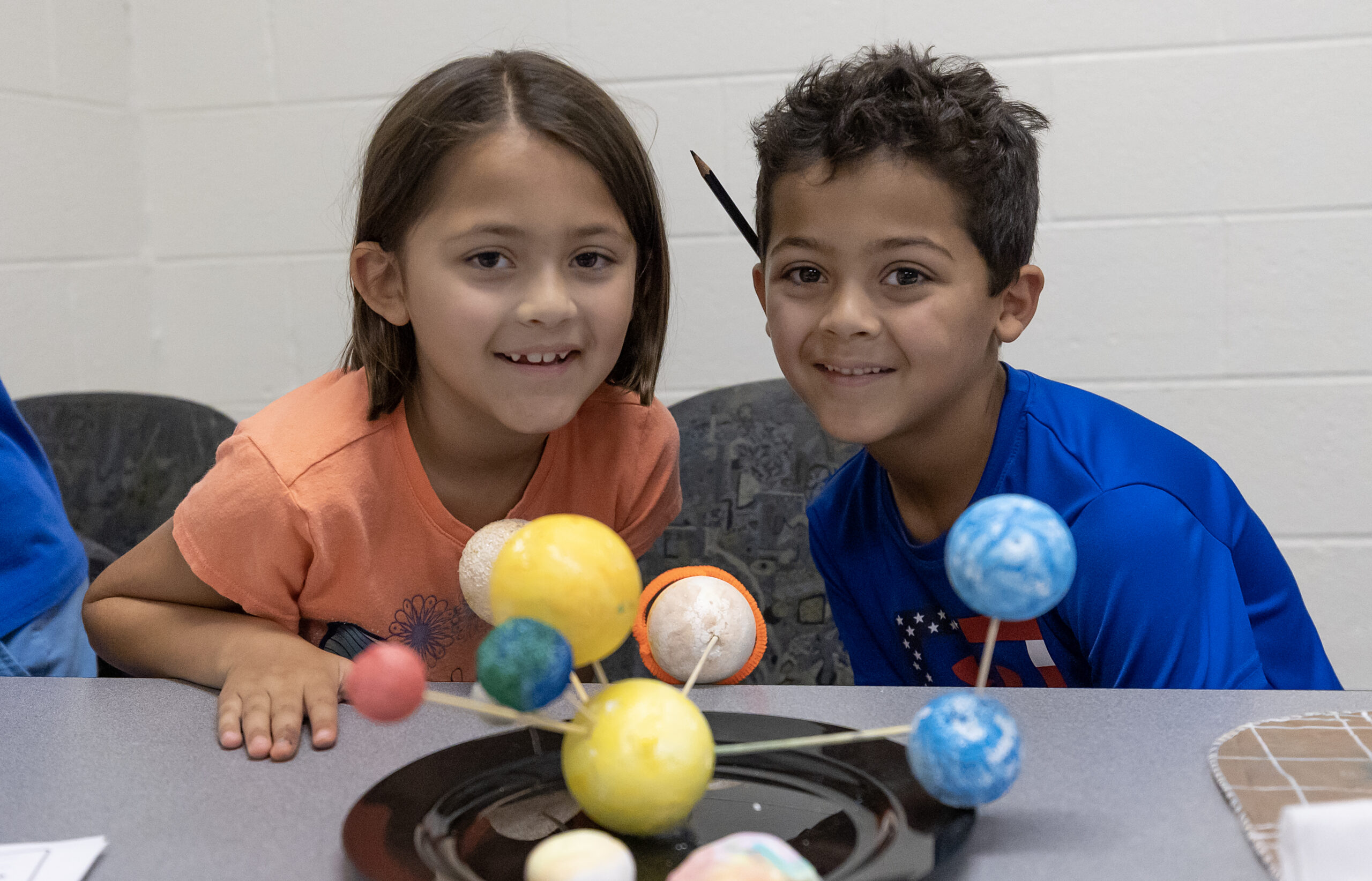 two kids smiling doing crafts