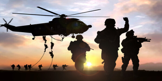 silhouette of marines and helicopter