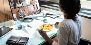 person eating and in a zoom meeting