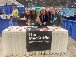 The MacGuffin staff at a table booth