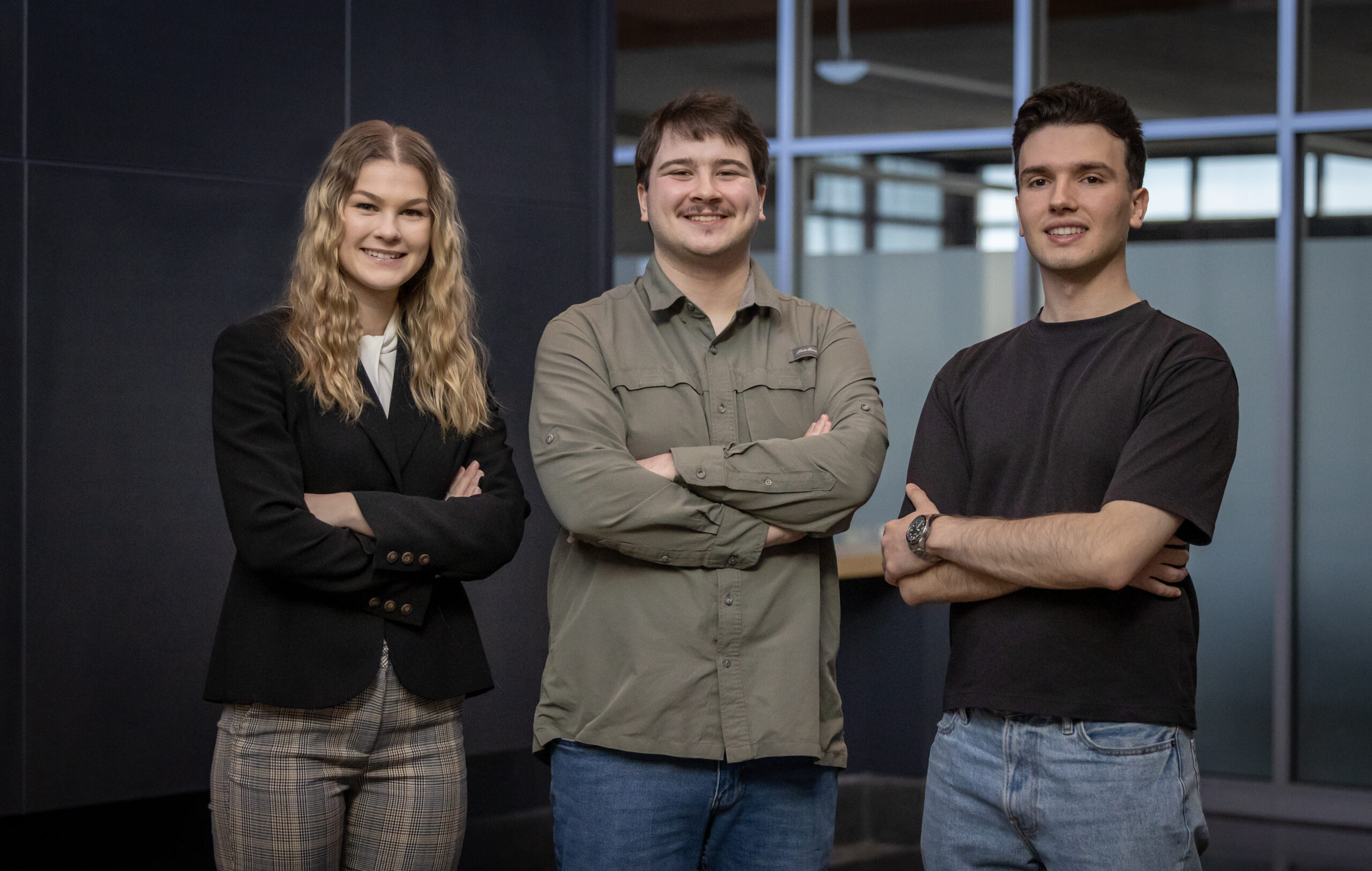 three students smiling