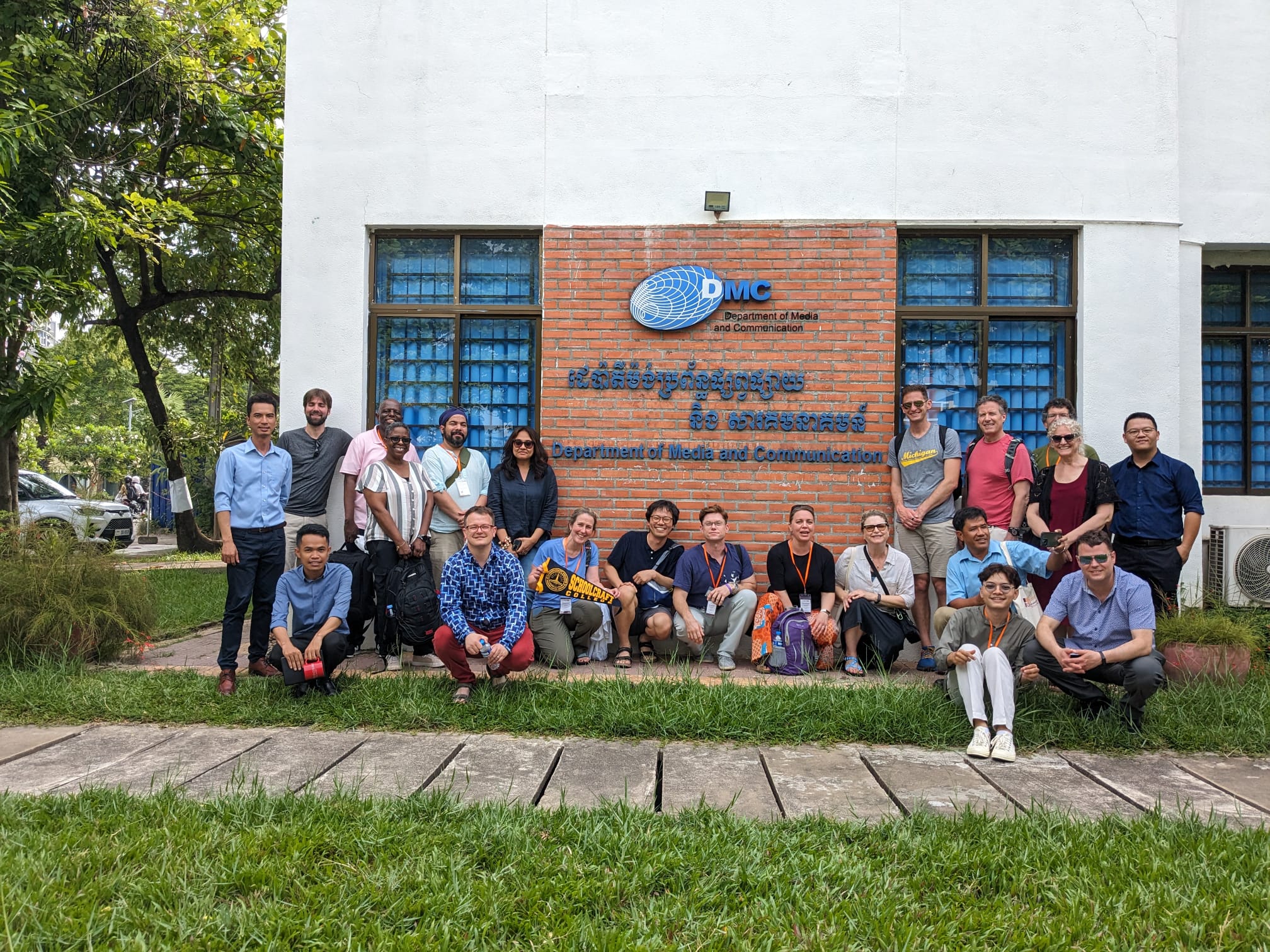 large group photo in front of DMC building
