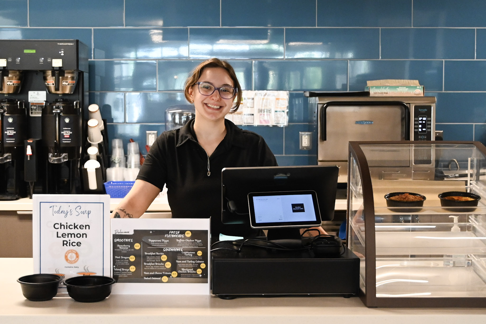 cashier smiling at register counter
