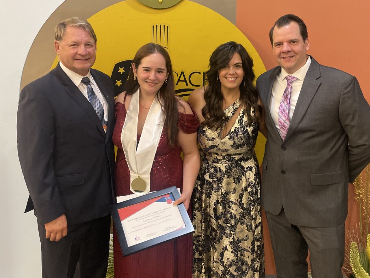 group of four holding an award